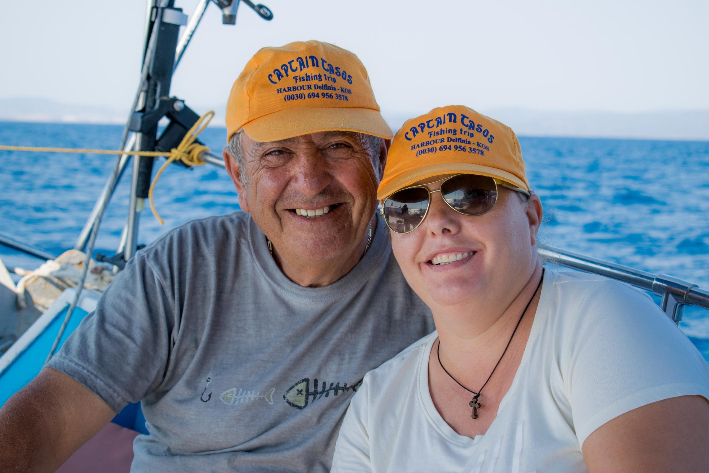 Alex and Mariana on board in Captain Tasos caps, out on the Aegean off Kos