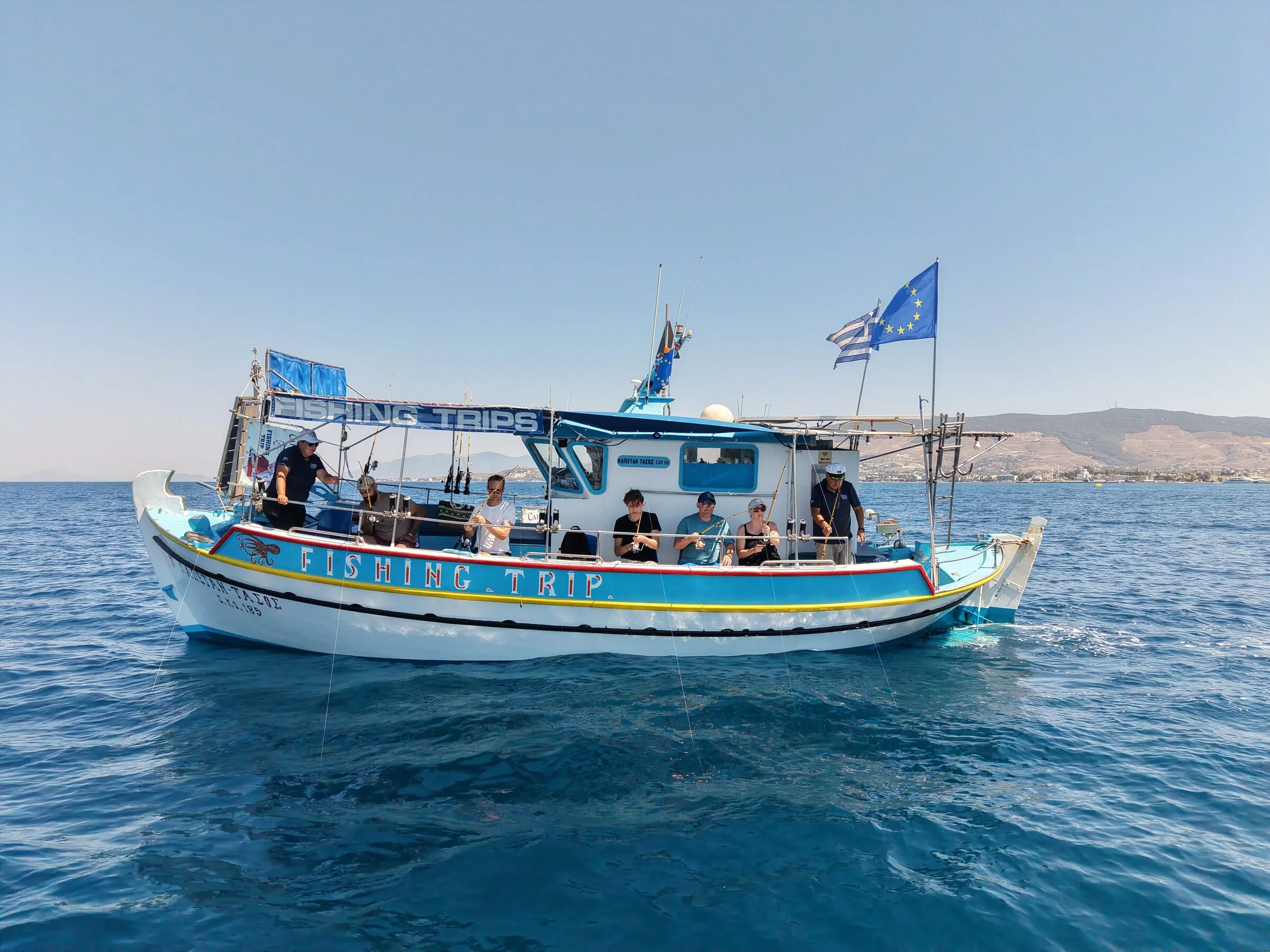 Guests fishing from the rail of the Captain Tasos on the Aegean off Kos