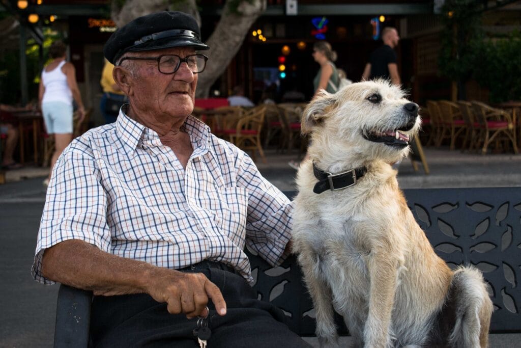 Captain Tasos sitting with his dog in Kos Town