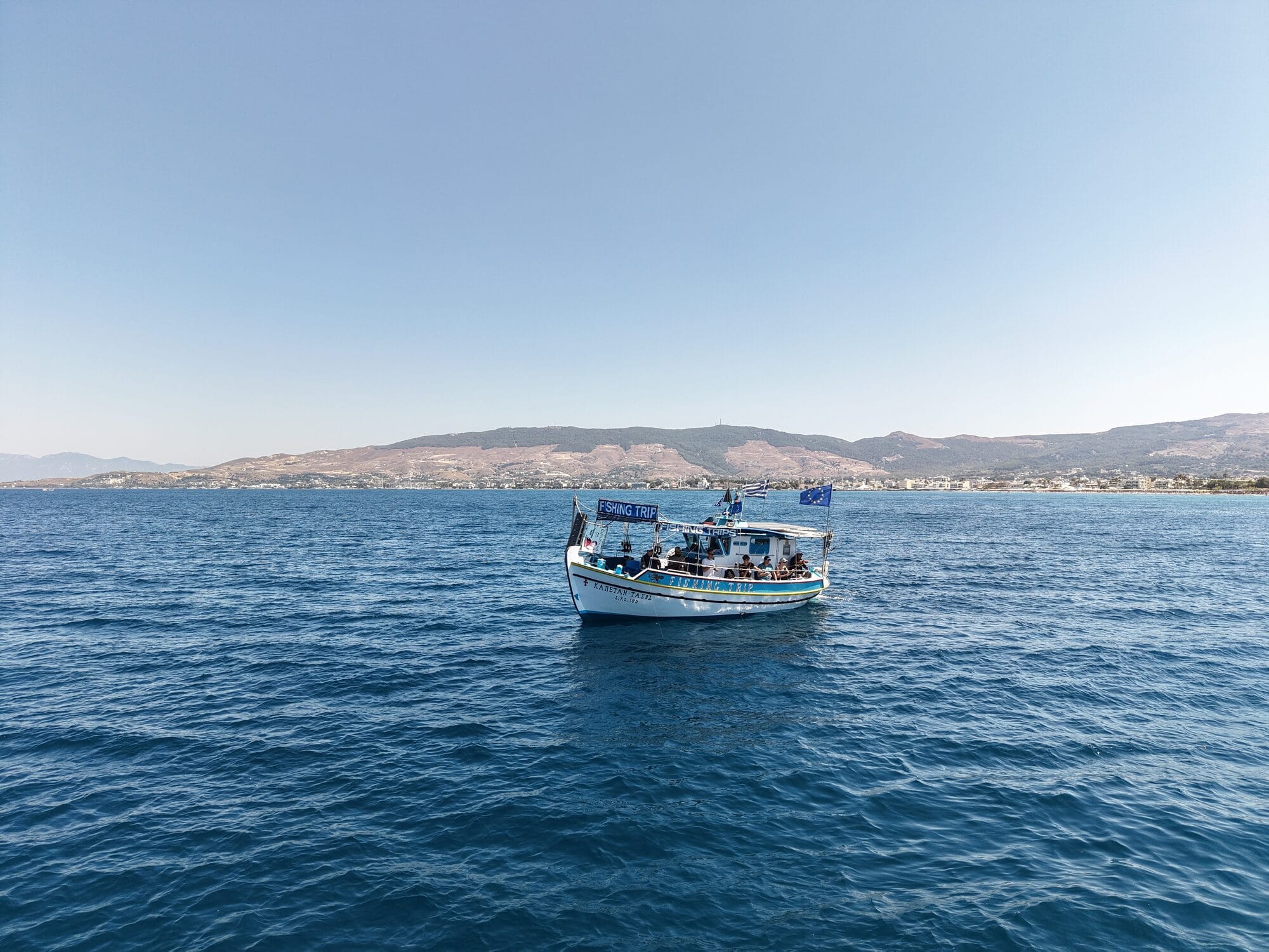 The Captain Tasos on open water with the Kos coastline behind