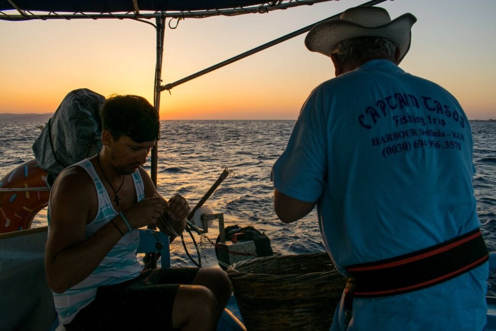 Crew working on board the Captain Tasos at sunset off Kos