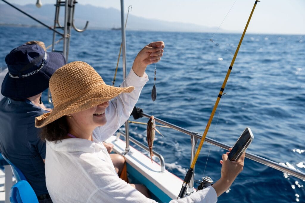 A guest on the Captain Tasos holding up a fishing rig on the Aegean
