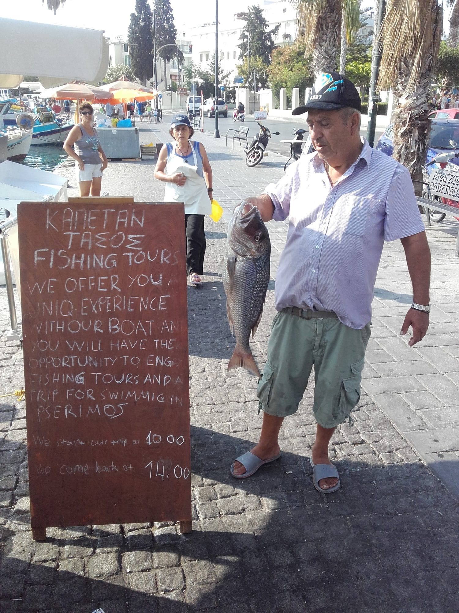 August 2016. Alex on the quay beside the hand-painted board that advertised the trips.