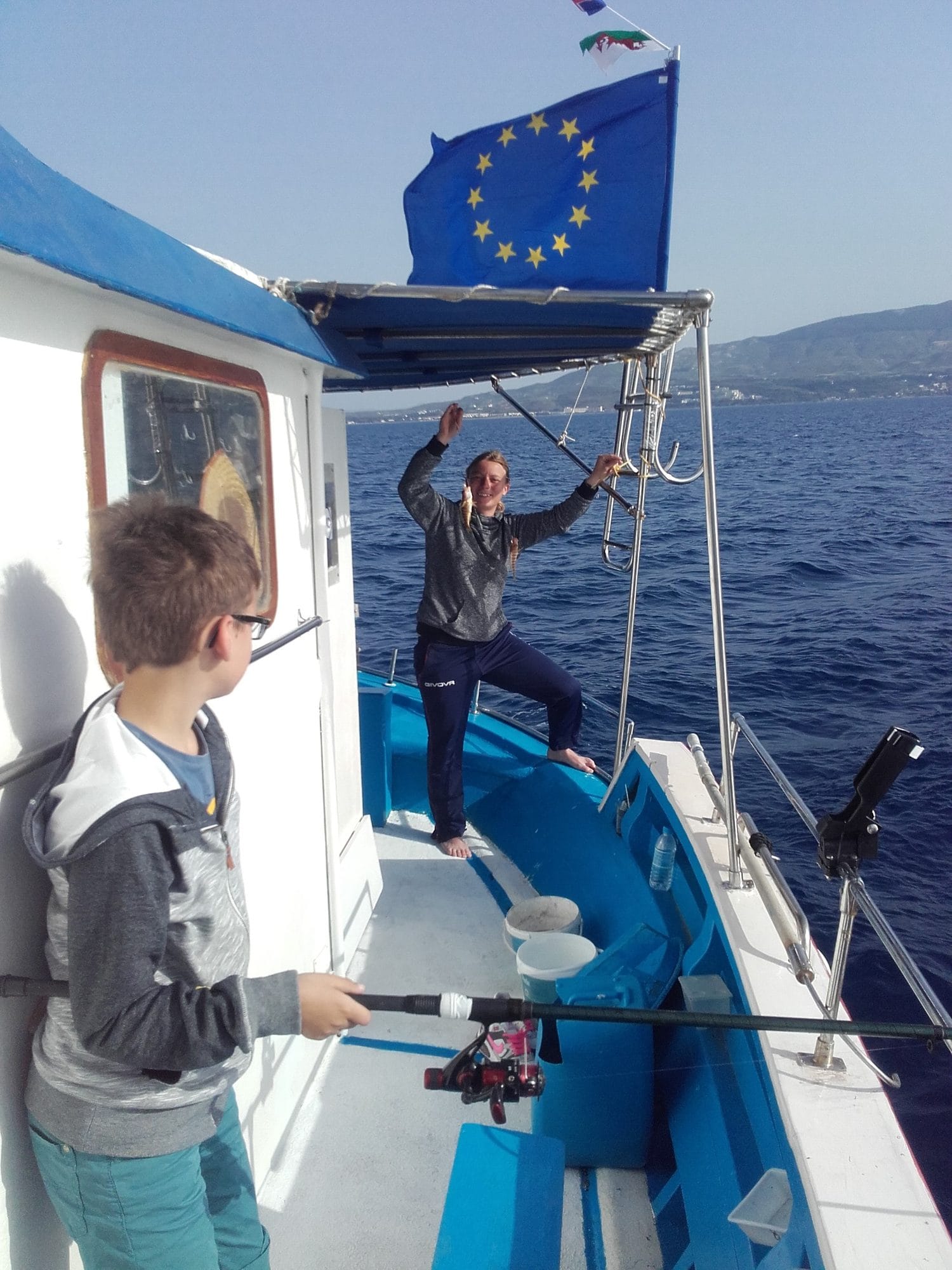 May 2017. Timi at the bow while a young guest fishes from the deck.